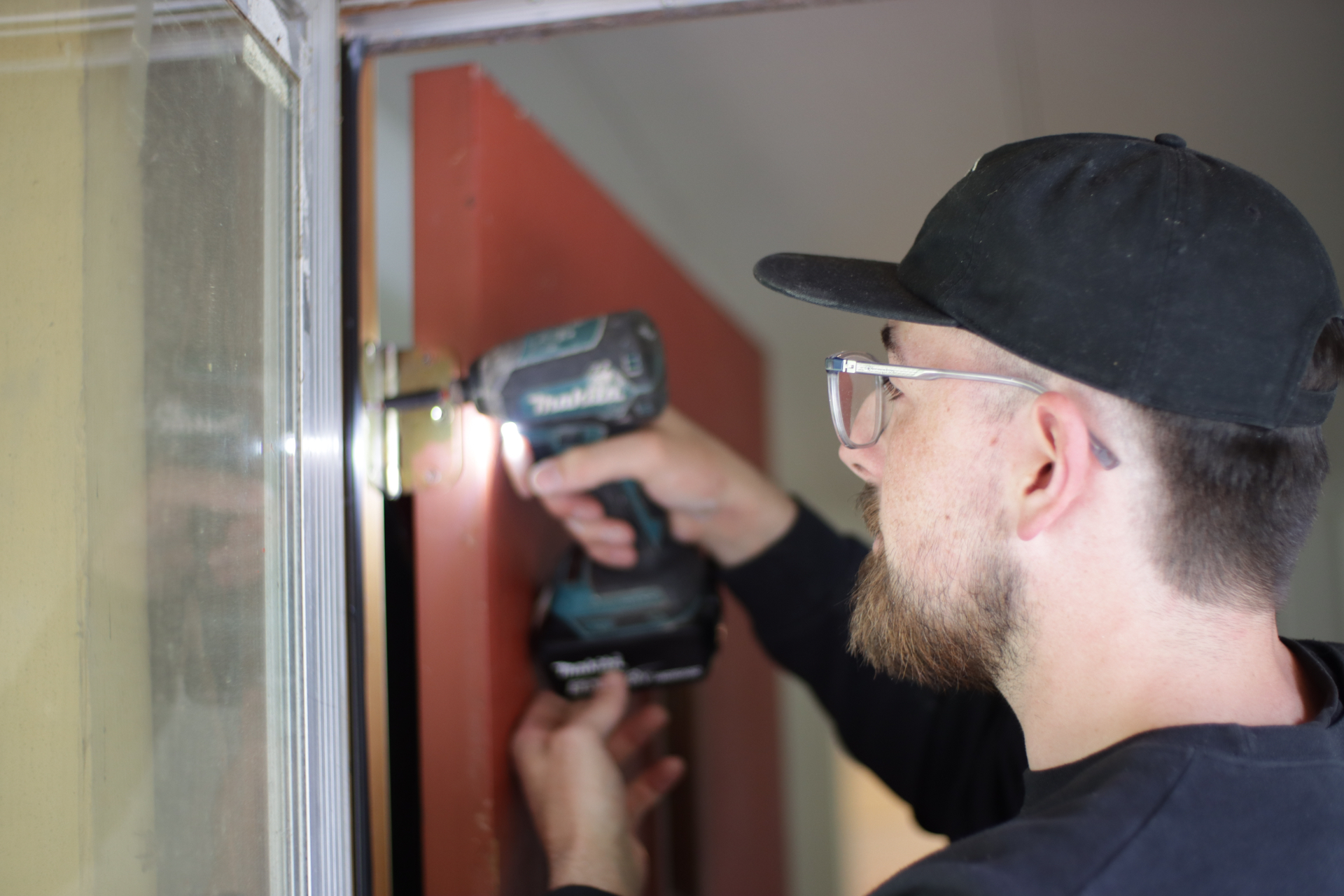 Keenon installing hardware on a front door